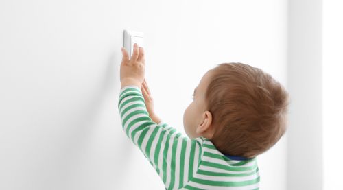 baby reaching light switch