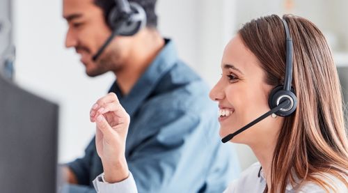 team wearing headsets and talking to screens