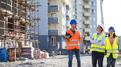 group with safety gear inspecting construction site