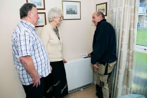 people gathered around dimplex quantum storage heater in living room