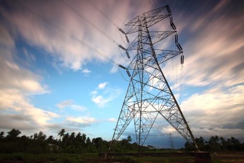 electricity pylon with clouds in the background