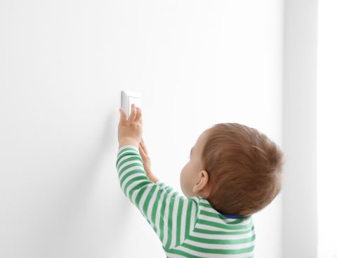 baby reaching light switch