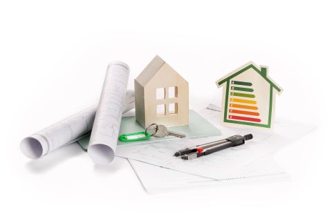 model house with blueprints and ecology rating chart