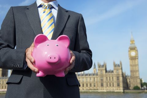 Businessman holding piggy bank