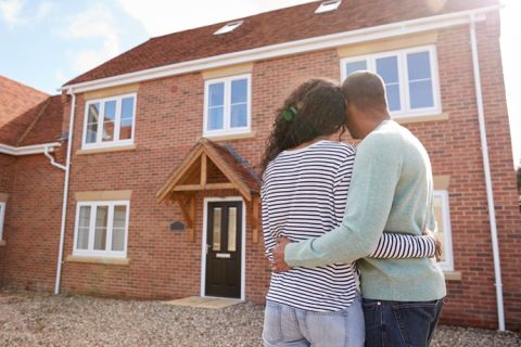 backshot of couple looking at their house