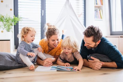 happy family on the floor reading book