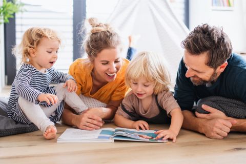 family reading on the floor