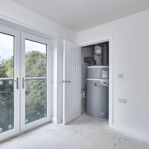 heat pump cylinder in a cupboard