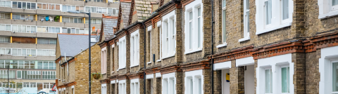 Traditional English terraced houses with huge council block in the background