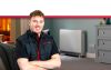 Image showing proud apprentice in forgraound and quantum heater in background